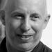 Costanzo Ranci, is in a black and white photo, wearing a dark top smiling 
