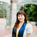 A lady wearing a graduation sash from University of Berkeley class of 2023