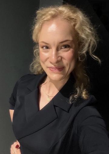 Alicja Borzyszkowska wears a dark-coloured blazer and has blonde hair.