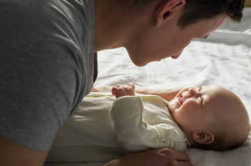 parent and a baby looking at each other