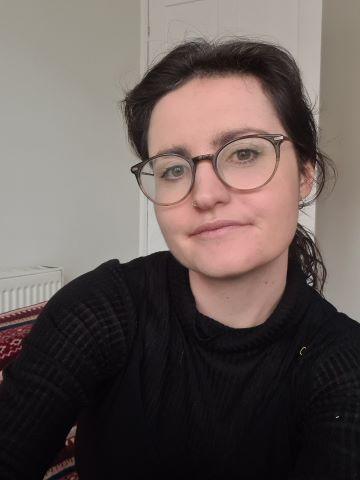 Rosemary O'Connor resize An image of Rosemary, a woman with long dark hair and brown eyes. She is wearing a black top and round glasses. Her hair is tied back into a ponytail.