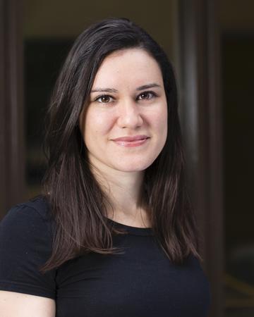 Dr Gabriela Pavarini Dr Gabriela Pavarini has shoulder length dark hair, waring a black top smiling gently at the camera.
