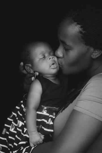 Mother kissing her baby