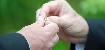 men holding a wedding ring