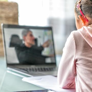 Child watching a lesson on a laptop 