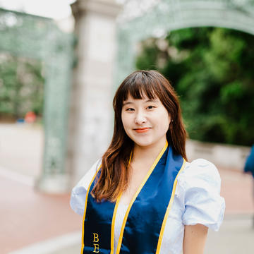 A lady wearing a graduation sash from University of Berkeley class of 2023