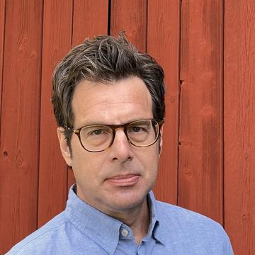 Kenneth Nelson Kenneth nelson is wearing glasses and a blue shirt looking directly at the camera.