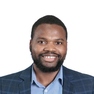 Dr Siyanai Zhou is wearing a dark blue with stripes jacket, with a blue shirt with short afro hair, smiling at the camera.