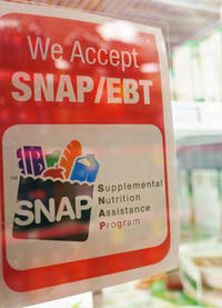Supermarket sign: We Accept SNAP/EBT - Supplemental Nutrition Assistant Program