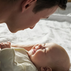 Parent looking at a baby smiling