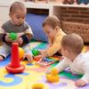 Three babies playing on a colourful floor matt. Photo credit: stock.adobe.com / Krakenimages.com