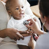 A doctor pressing a stethoscope to a baby's chest