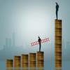 Income inequality vector image: one man standing on a small pile of money, another man standing on a large pile of money