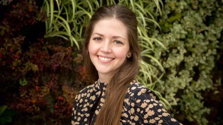 Ana Restrepo saenz has long hair wearing a floral top smiling directly at the camera.