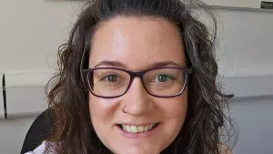  Hannah with long hair wearing glasses