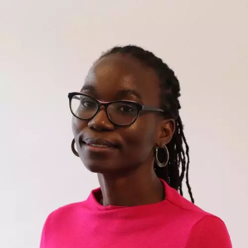Yvonne has long black braided hair, is wearing glasses and a cerise pink top