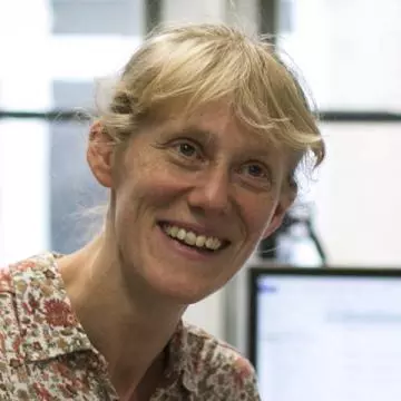 Tania is smiling at the camera, she has blonde hair and wearing a collared top with a floral pattern 