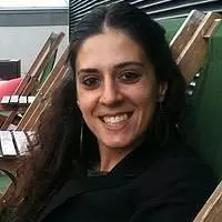 Ani has long black hair. She is wearing a black shirt and blazer