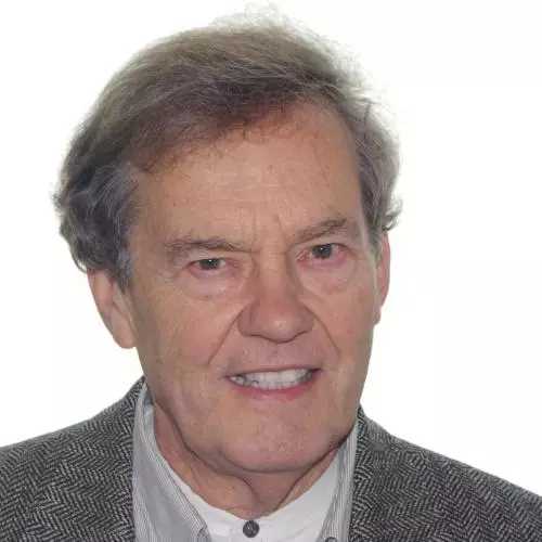 John Haskey has grey hair and is smiling at the camera. He is wearing a shirt and jacket.