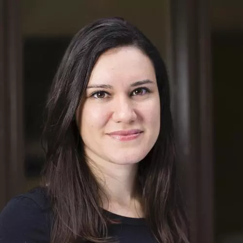 Dr Gabriela Pavarini has shoulder length dark hair, wearing a black top smiling gently at the camera.