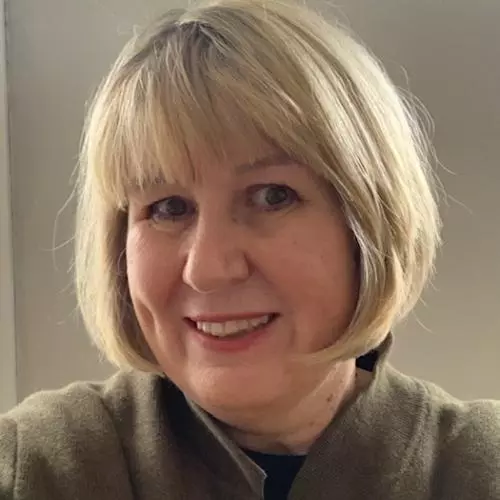 Rachel Yates has a blond bob hairstyle, smiling directly at the camera.