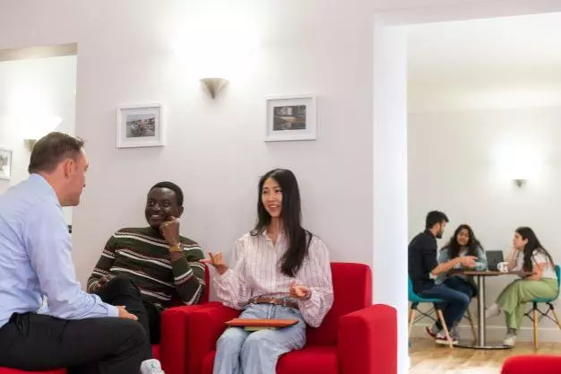 DSPI students relaxing with hot drinks and chatting 